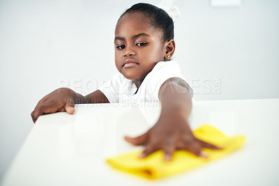 Buy stock photo African child, wipe and cleaning table in home kitchen for hygiene, chores and housekeeping maintenance. Girl, kid and cloth on counter for learning housework, education and help for development