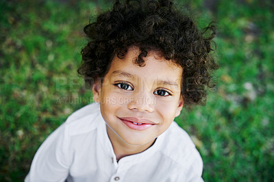 Buy stock photo Shot of a little boy smiling in nature