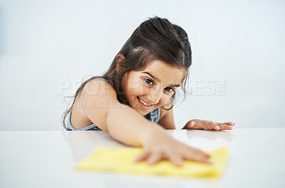 Buy stock photo Happy child, cloth and cleaning table in home for hygiene, chores and housekeeping maintenance. Girl, kid and wipe kitchen counter for learning housework, education or help for development in house