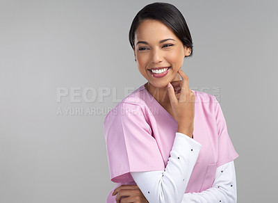 Buy stock photo Cropped shot of an attractive young female healthcare worker standing in studio against a grey background