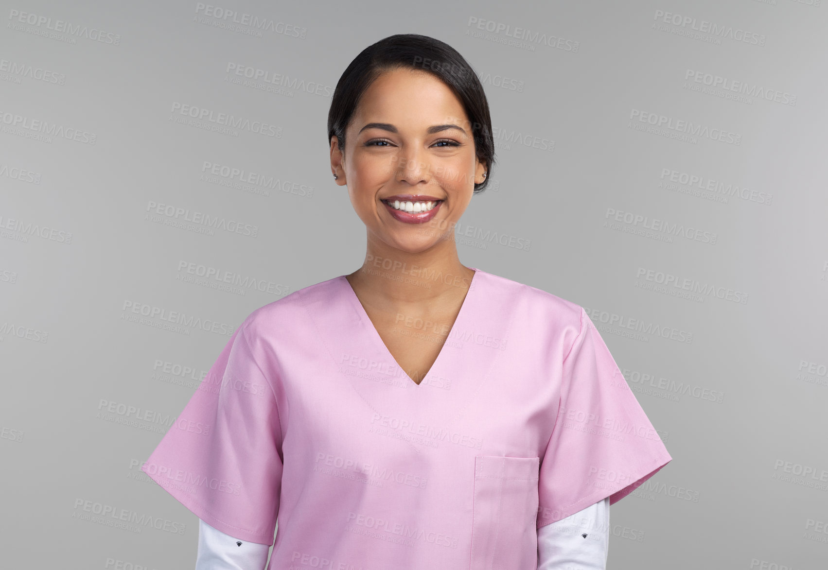 Buy stock photo Cropped portrait of an attractive young female healthcare worker standing in studio against a grey background