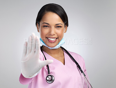 Buy stock photo Cropped portrait of an attractive young female healthcare worker gesturing stop while standing in studio against a grey background