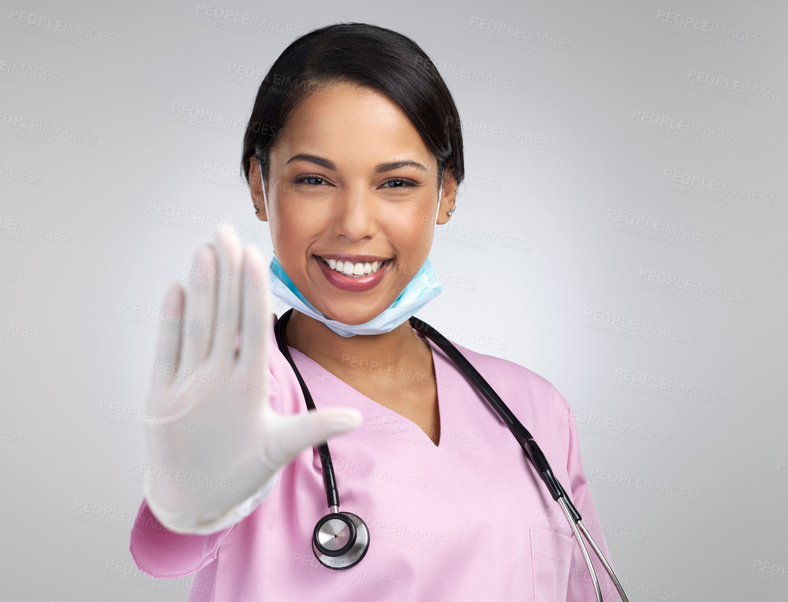 Buy stock photo Cropped portrait of an attractive young female healthcare worker gesturing stop while standing in studio against a grey background