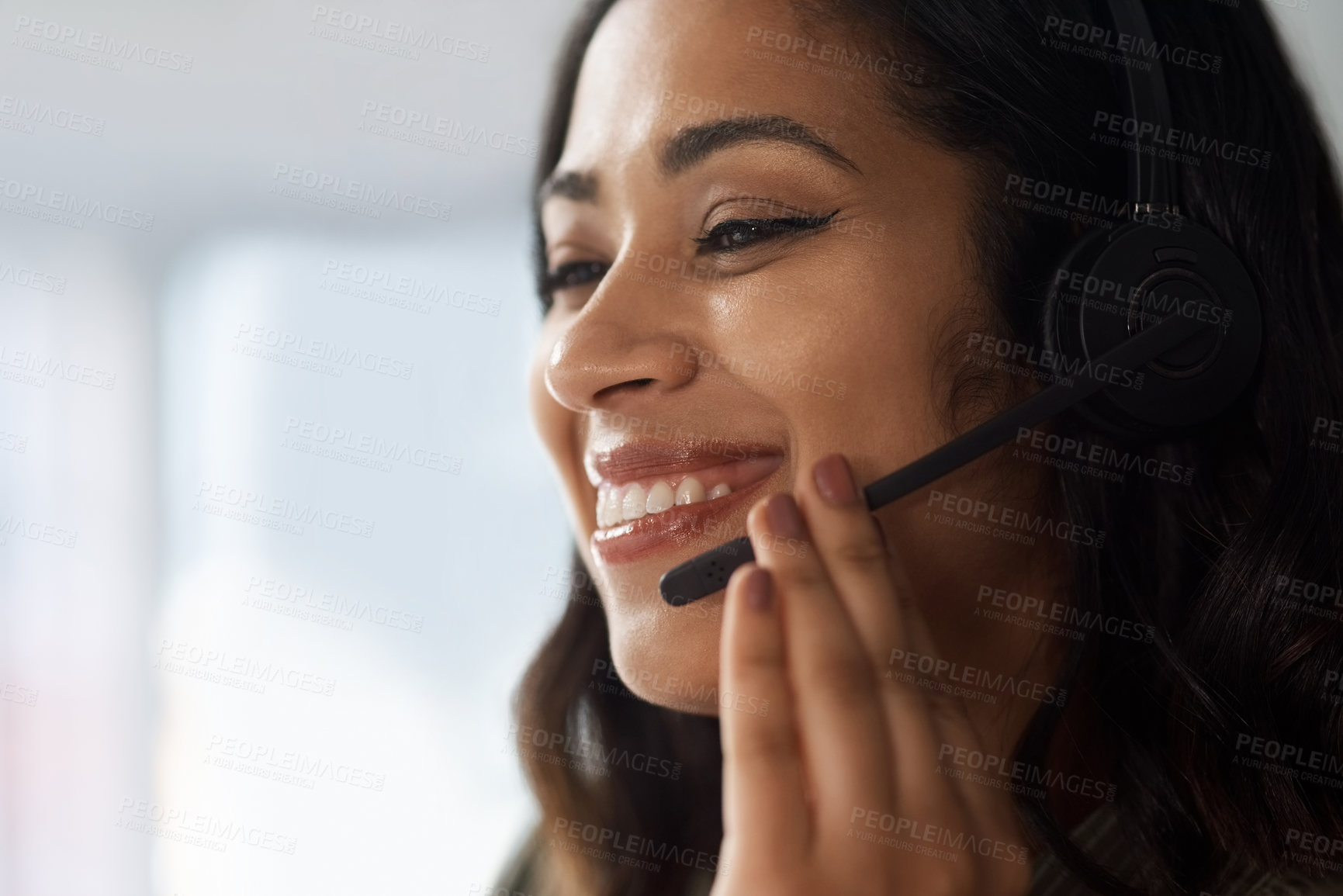 Buy stock photo Shot of a young businesswoman wearing a headset while working in a call centre