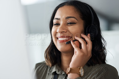 Buy stock photo Shot of a young businesswoman wearing a headset while working in a call centre