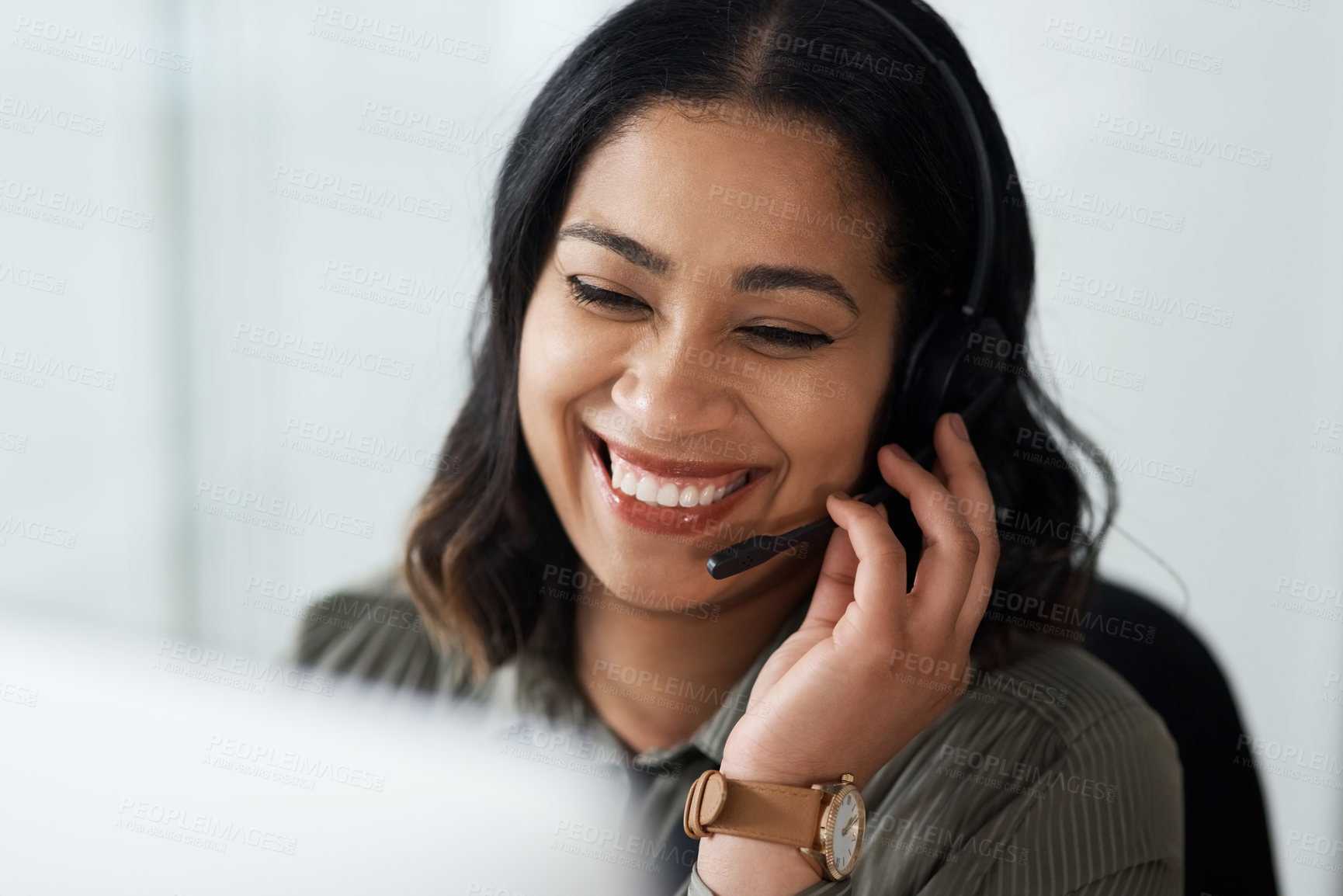 Buy stock photo Shot of a young businesswoman wearing a headset while working in a call centre