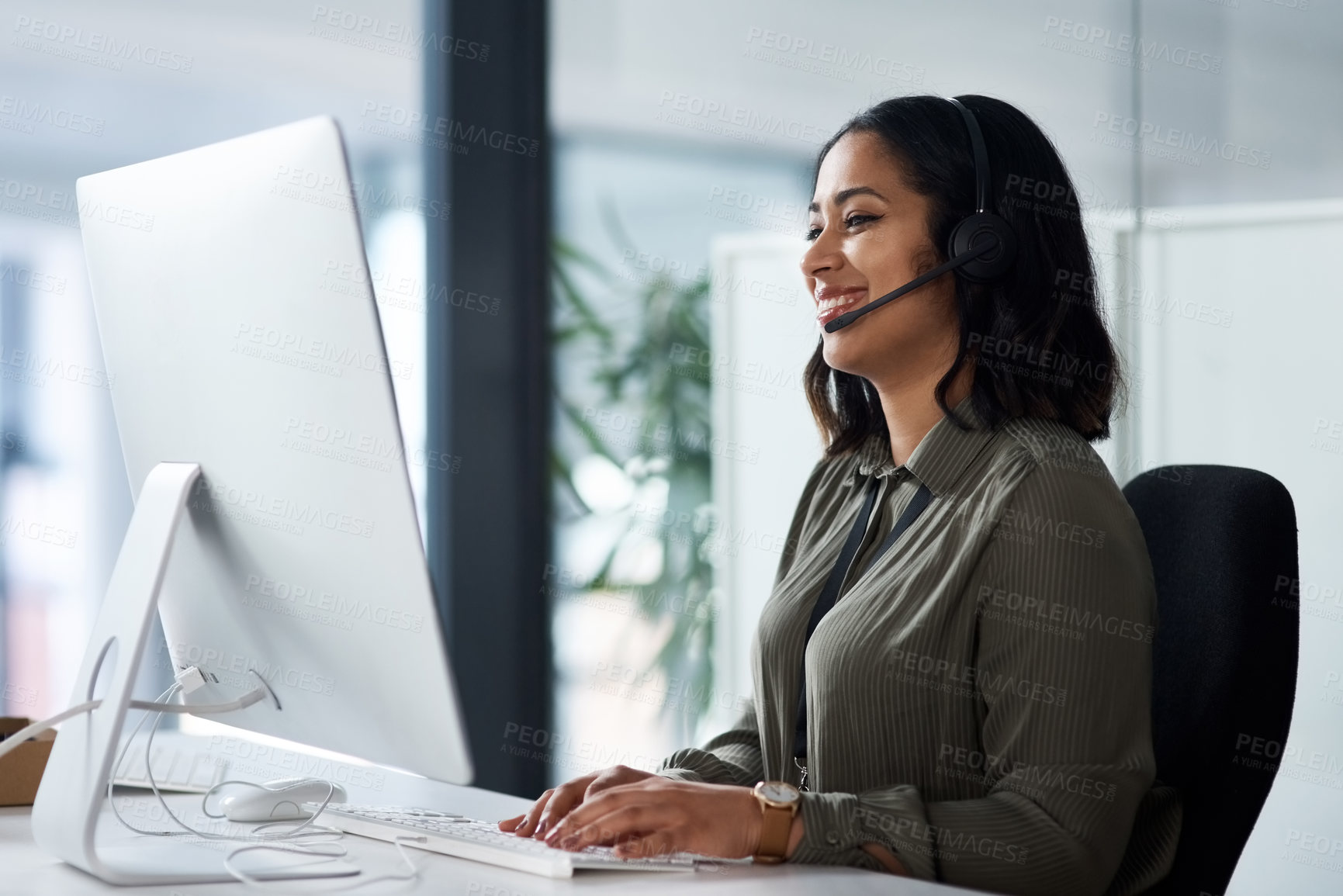 Buy stock photo Shot of a woman wearing a headset while looking at her desktop in a call centre