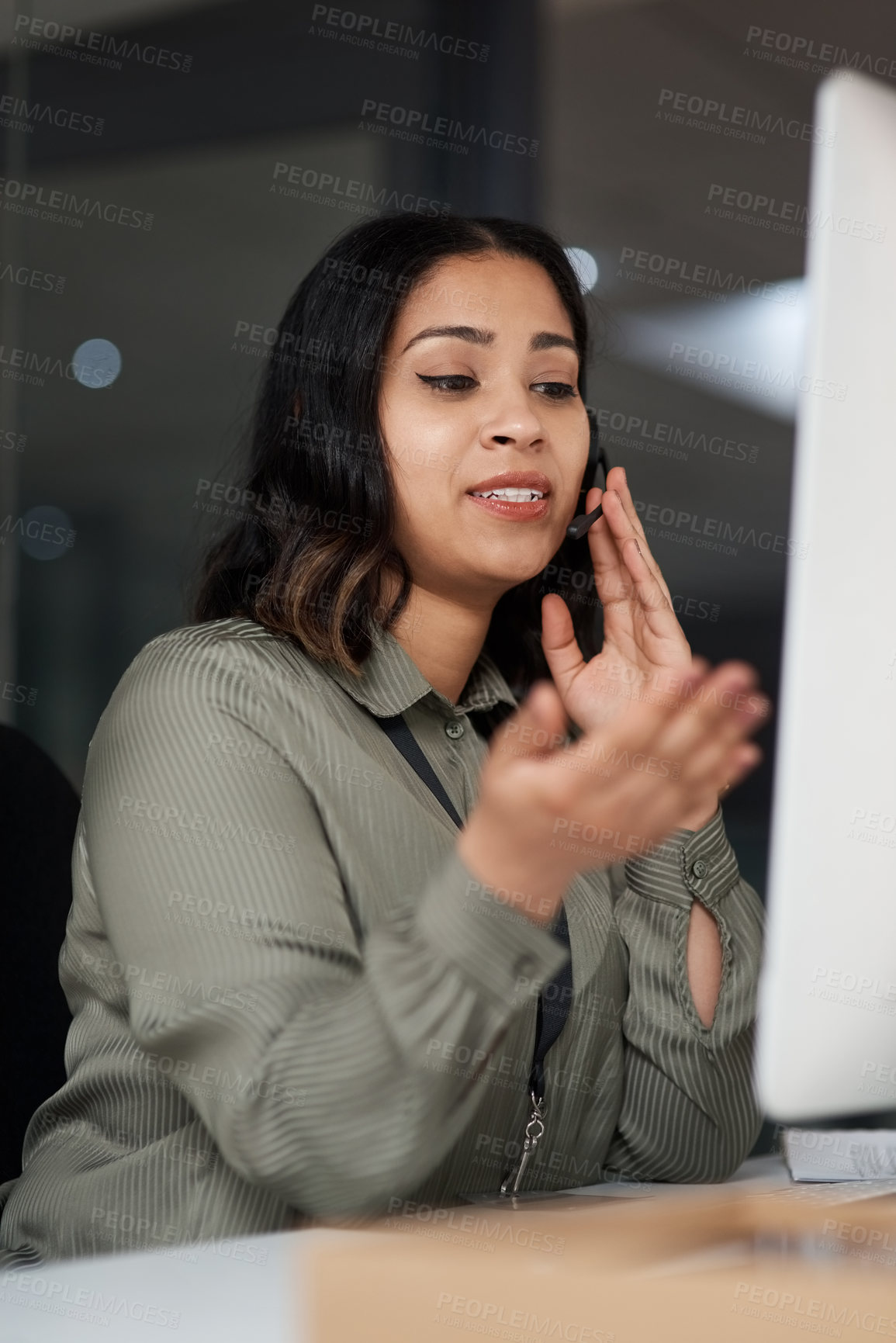 Buy stock photo Shot of a woman wearing a headset while looking at her desktop in a call centre