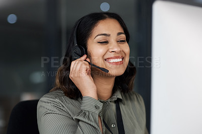 Buy stock photo Shot of a woman wearing a headset while looking at her desktop in a call centre