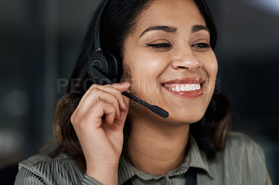 Buy stock photo Shot of a young businesswoman wearing a headset while working in a call centre