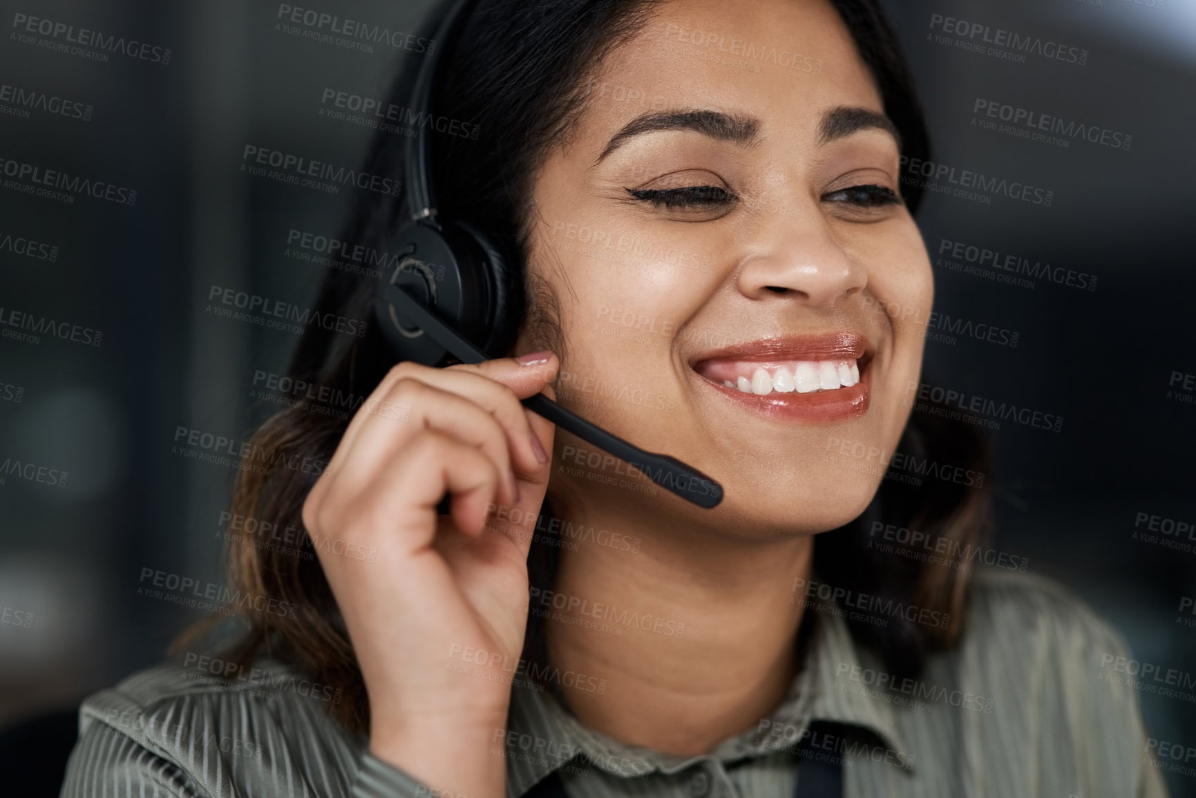 Buy stock photo Shot of a young businesswoman wearing a headset while working in a call centre