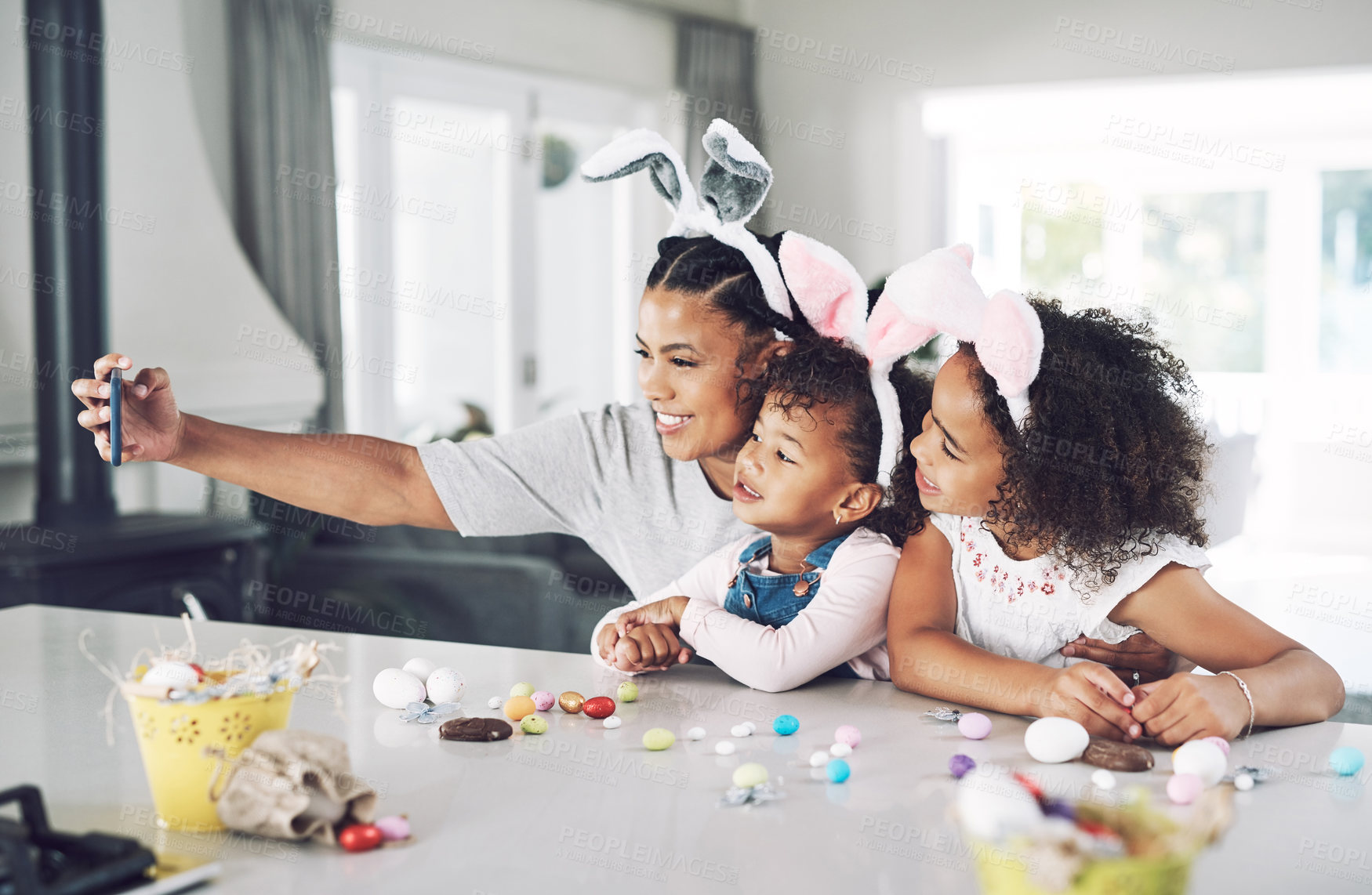 Buy stock photo Shot of a mother taking a selfie with her daughters at home