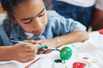 Buy stock photo Cropped shot of a young girl painting eggs at home