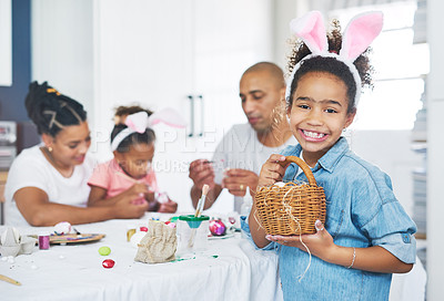 Buy stock photo Shot of a mother and father painting eggs with their daughter at home
