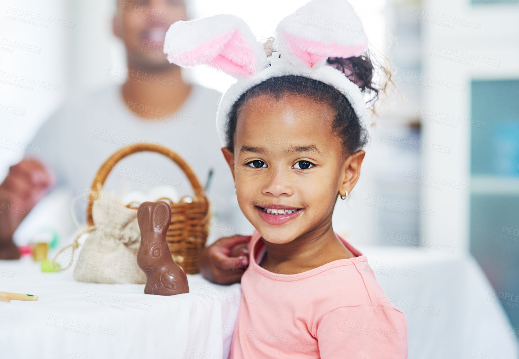 Buy stock photo Easter, portrait or kid in home with bunny ears for festive celebration, smile and relax with family. Chocolate rabbit, child and girl in apartment for holiday, cute and adorable with happiness