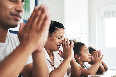 Buy stock photo Shot of a family praying together at home