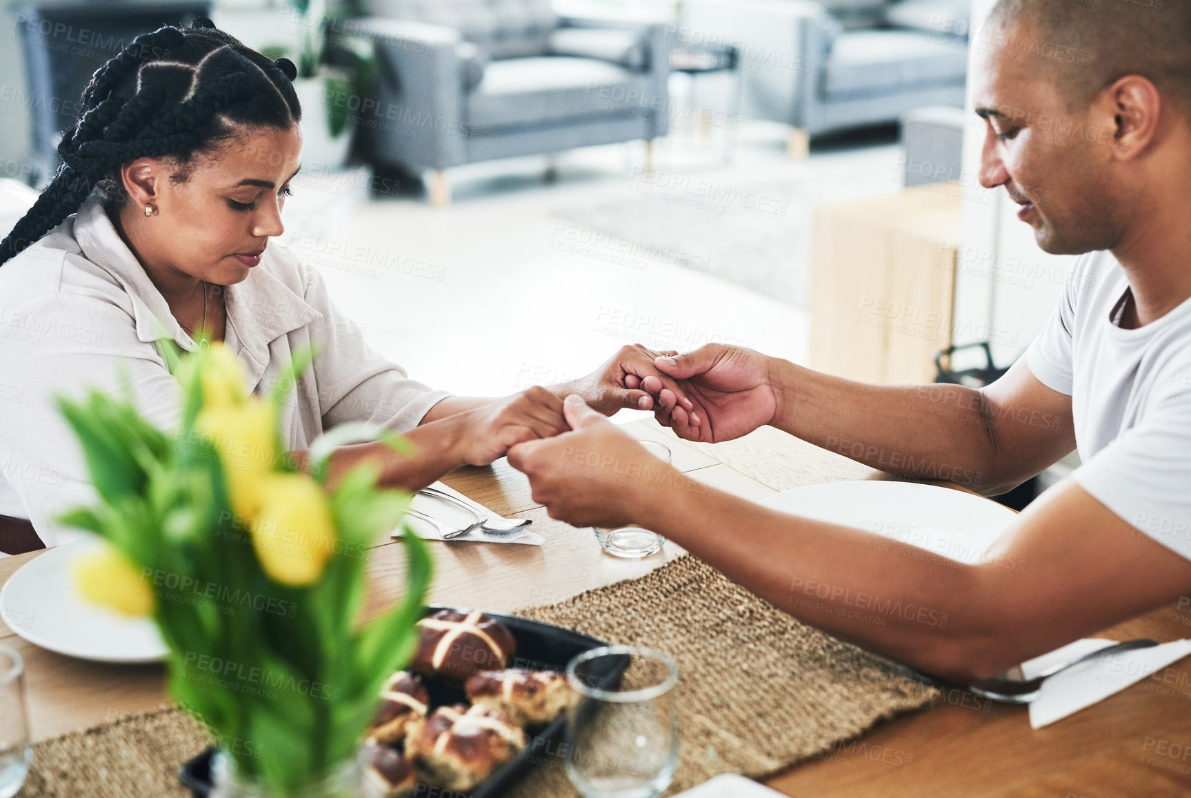 Buy stock photo Shot of a couple praying together at home