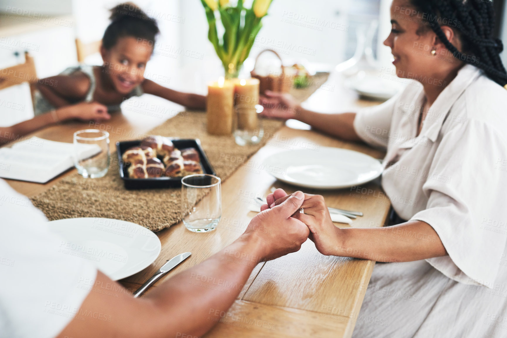 Buy stock photo Shot of an unrecognizable family holding hands during prayer time at home