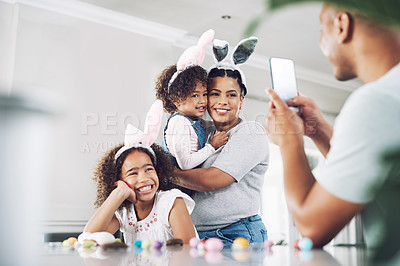 Buy stock photo Shot of a father taking a photo of his family at home