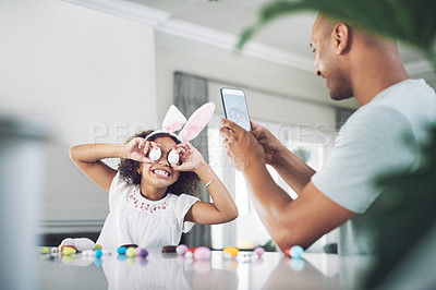 Buy stock photo Shot of a father taking a photo of his daughter at home