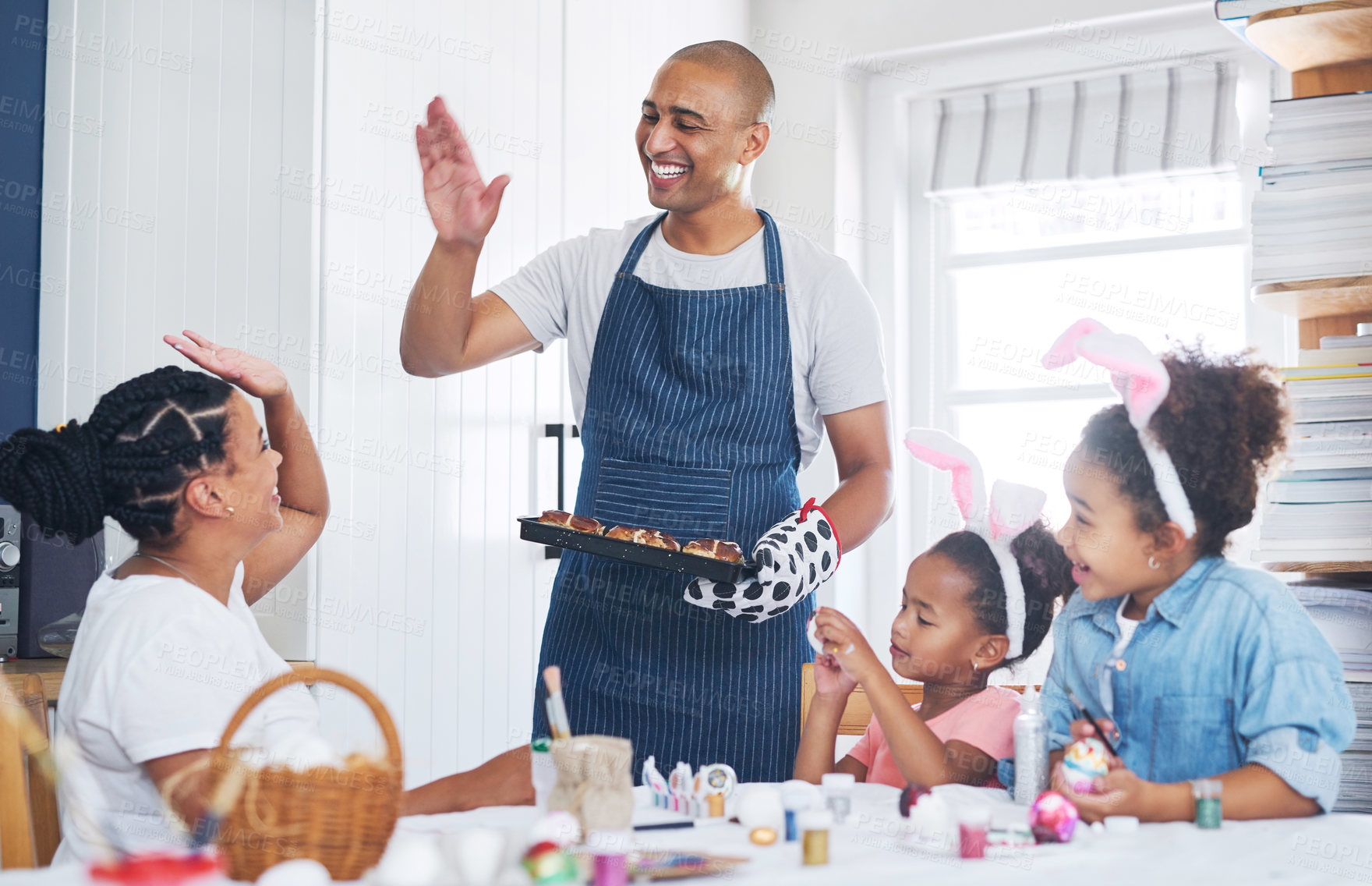 Buy stock photo Easter, baking and high five with parents, kids and decoration for festive holiday with family. Mom, dad or celebration with bunny ears, dessert tray or paint eggs with happy children in home kitchen