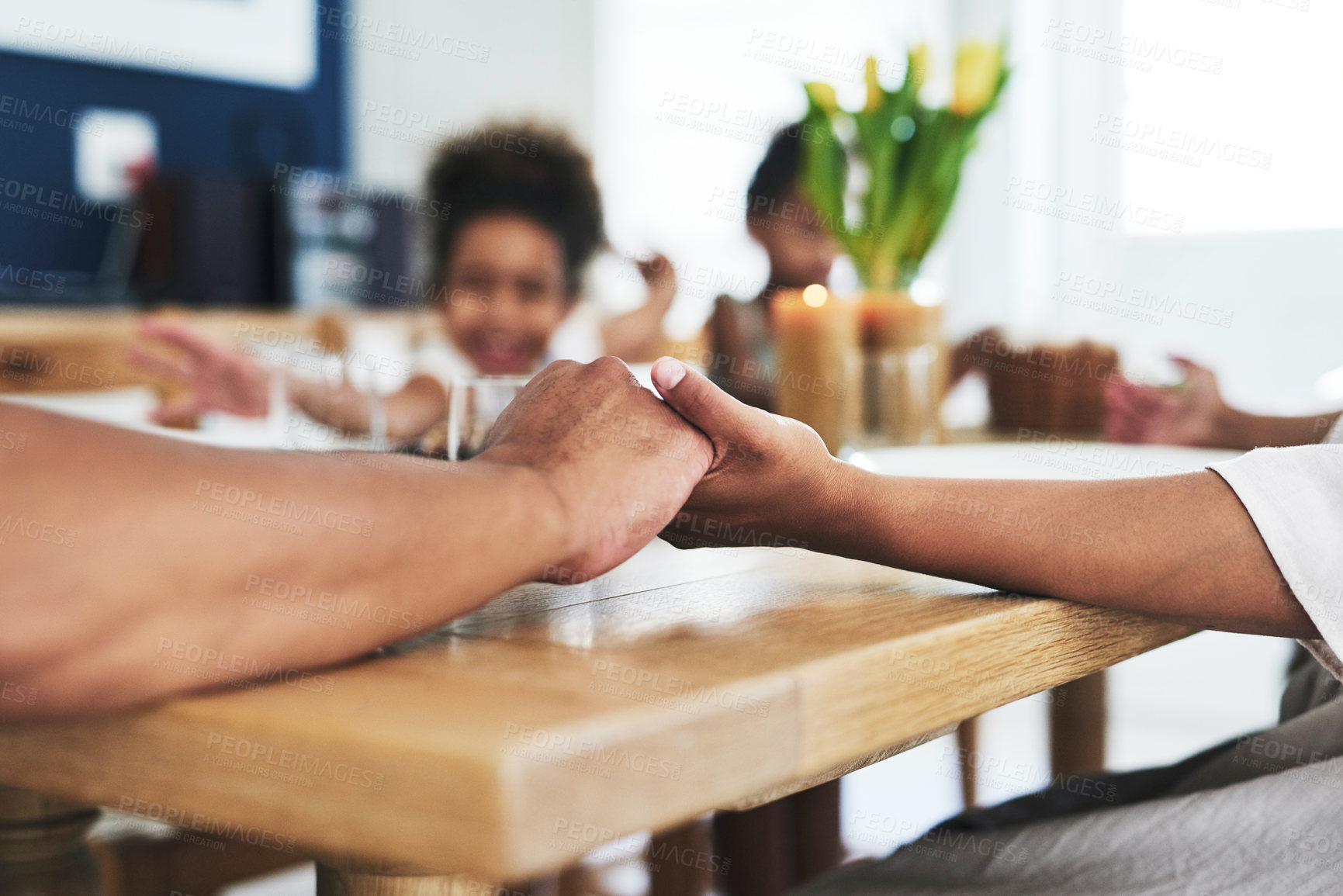 Buy stock photo Shot of an unrecognizable family holding hands during prayer time at home