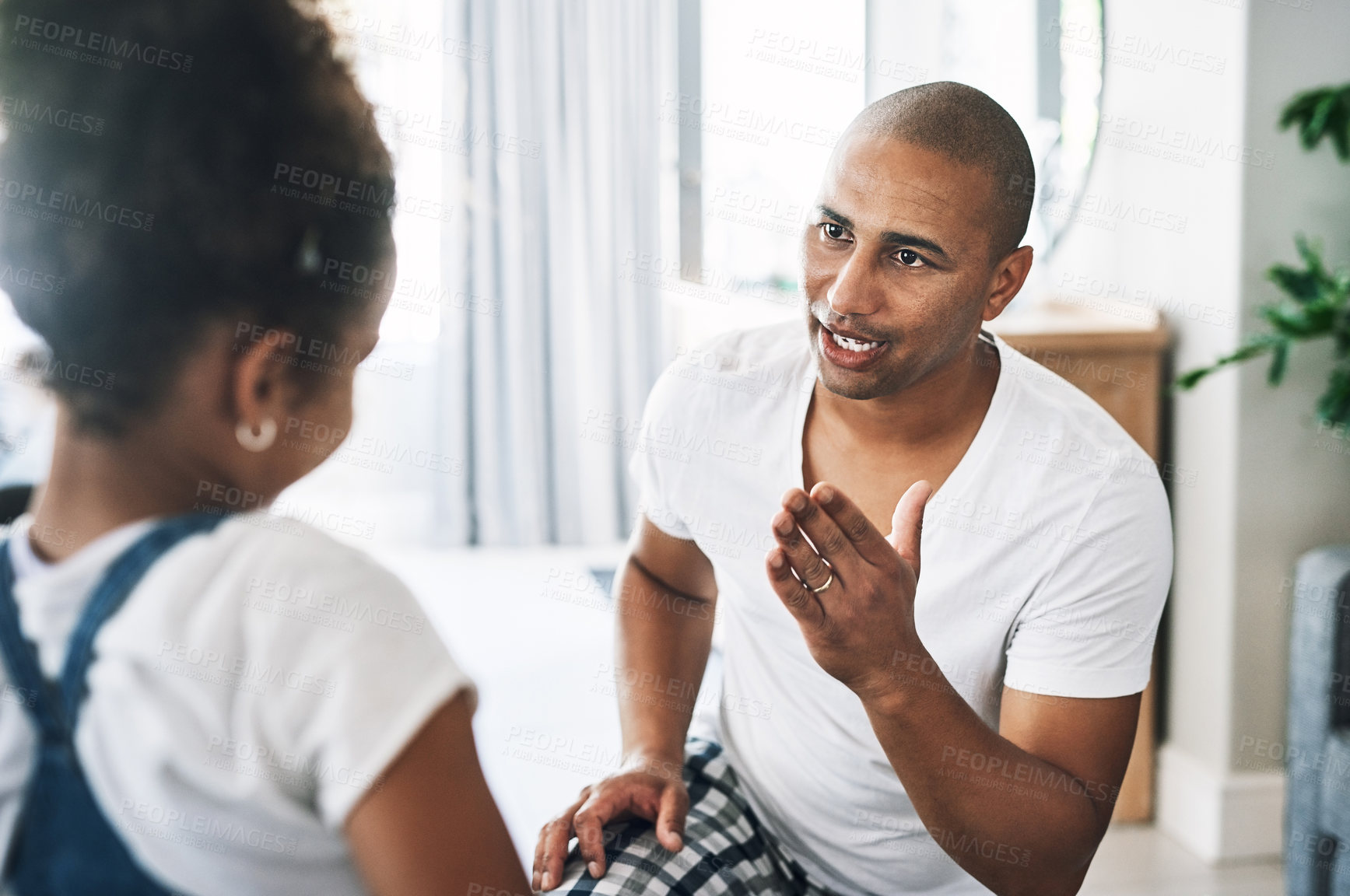 Buy stock photo Shot of a young father reprimanding a child at home