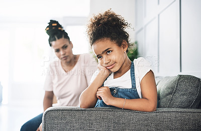 Buy stock photo Shot of a young mother reprimanding a child at home