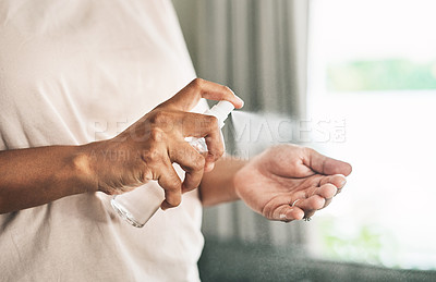 Buy stock photo Shot of unrecognizable person using hand sanitiser at home