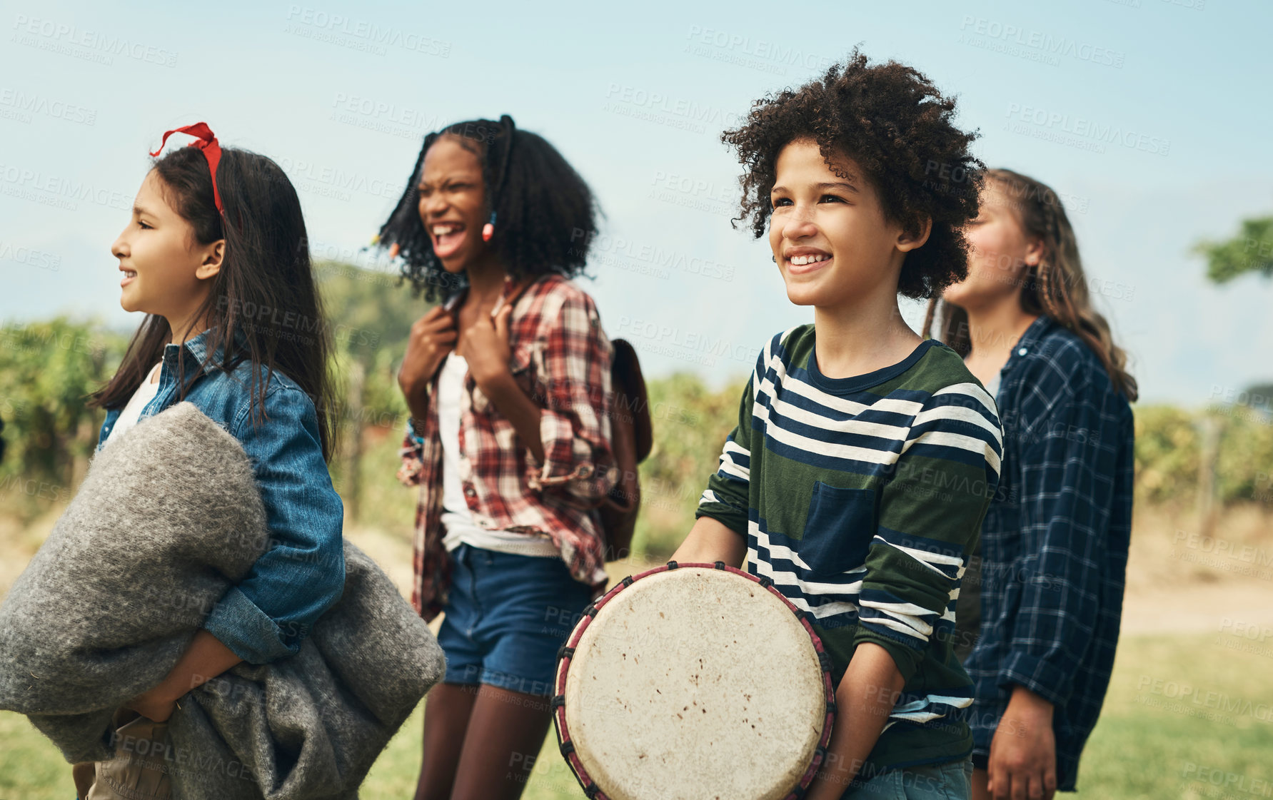 Buy stock photo Shot of a group of teenagers walking through nature together at summer camp