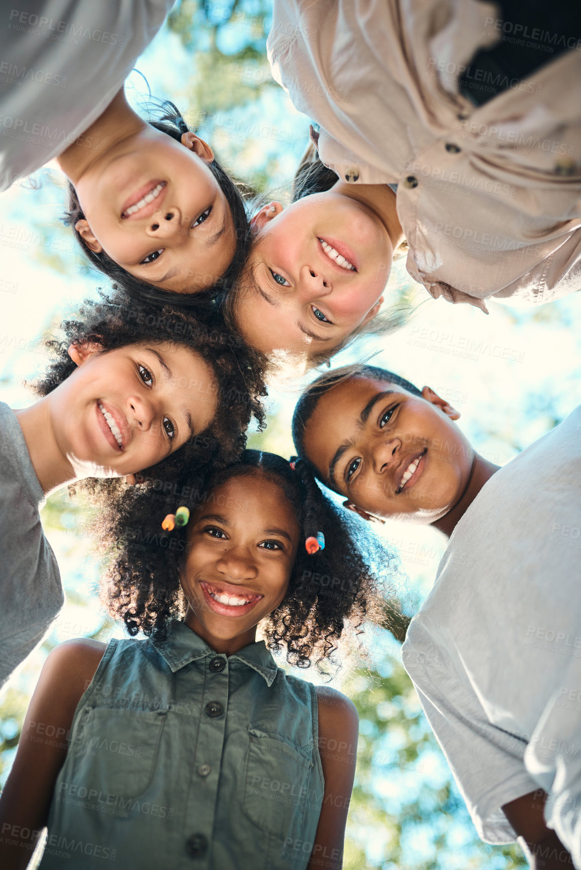 Buy stock photo Shot of a group of teenagers standing in a circle in nature at summer camp