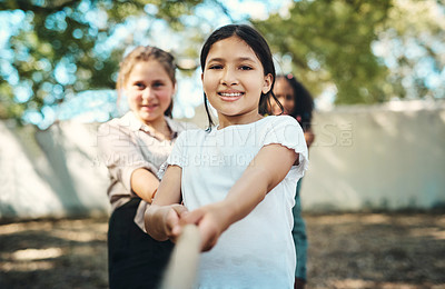 Buy stock photo Shot of a group of teenagers playing a game of tug of war at summer camp