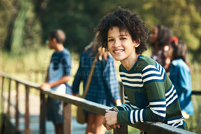 Buy stock photo Shot of a teenager boy standing on a bridge in nature at summer camp