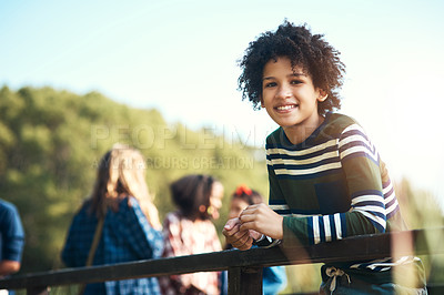 Buy stock photo Shot of a teenager boy standing on a bridge in nature at summer camp