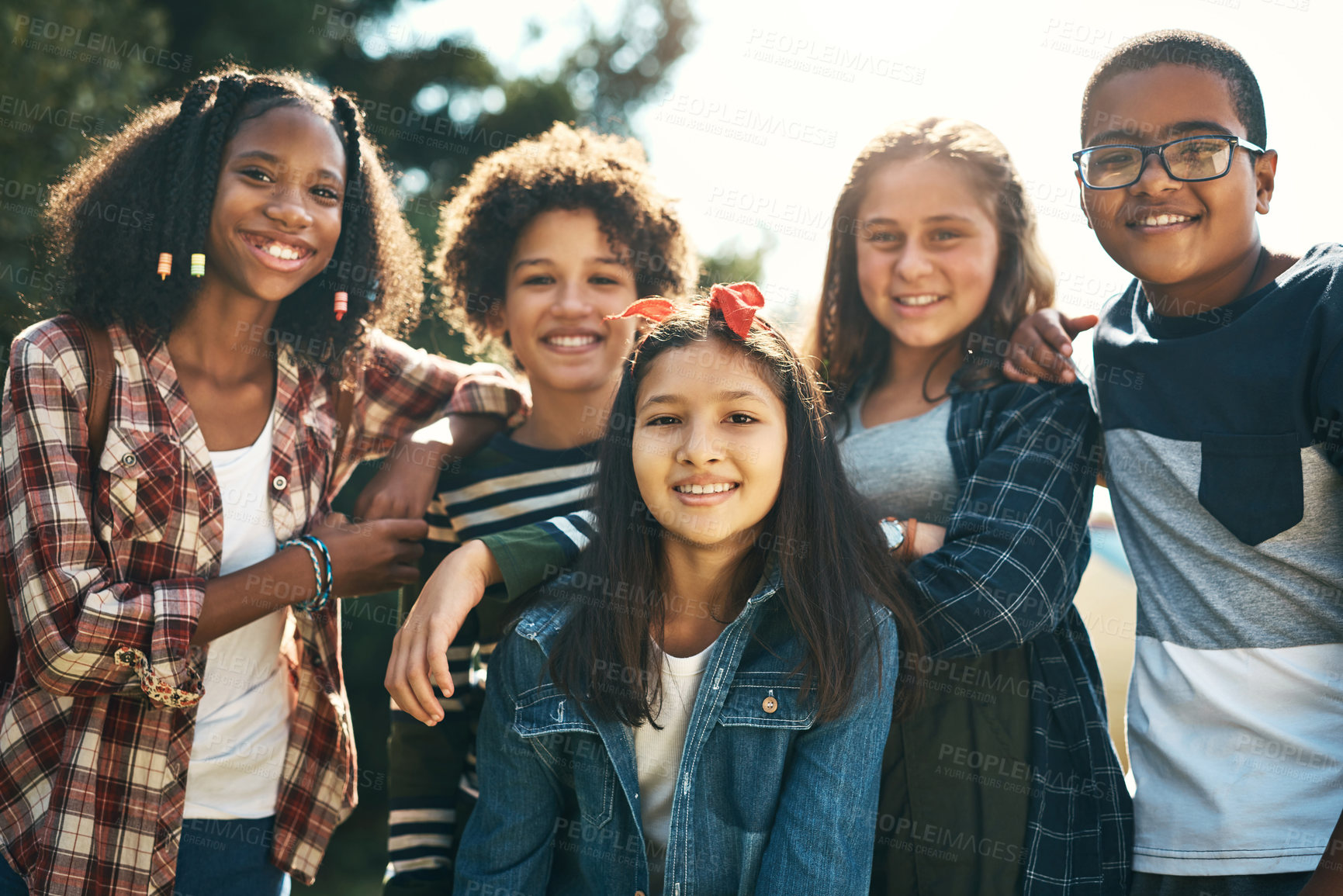 Buy stock photo Shot of a group of teenagers embracing in nature at summer camp