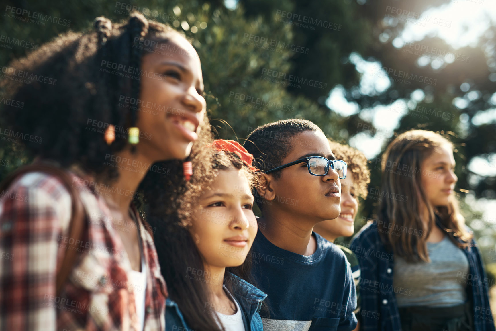 Buy stock photo Shot of a group of teenagers having fun in nature at summer camp