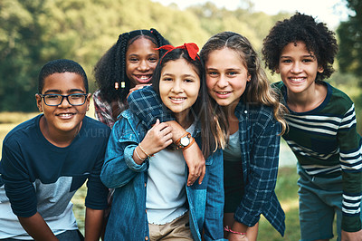 Buy stock photo Shot of a group of teenagers embracing in nature at summer camp