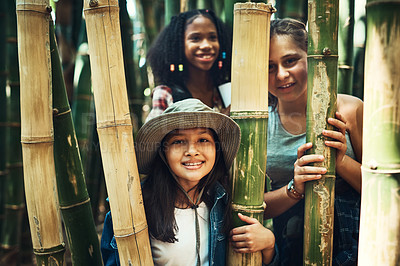 Buy stock photo Shot of a group of teenage girls exploring nature together at summer camp