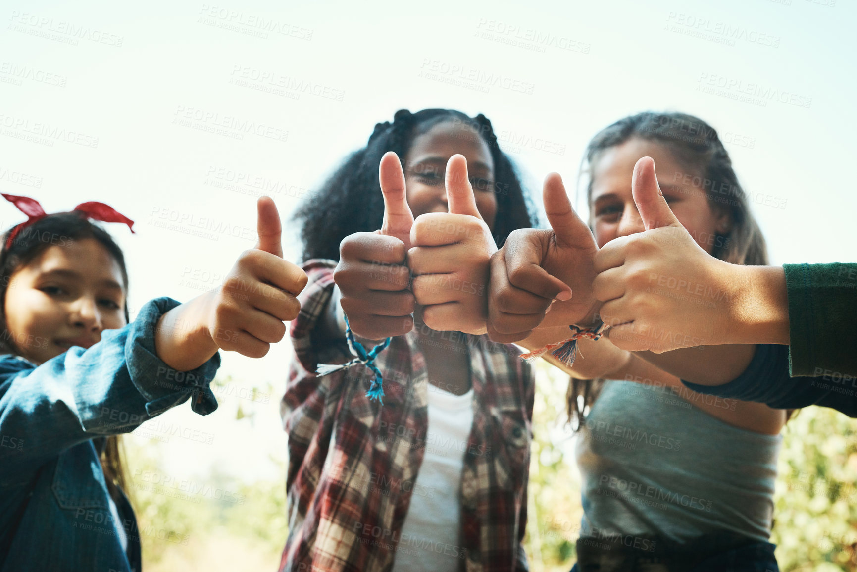 Buy stock photo Shot of a group of teenage girls showing thumbs up at summer camp