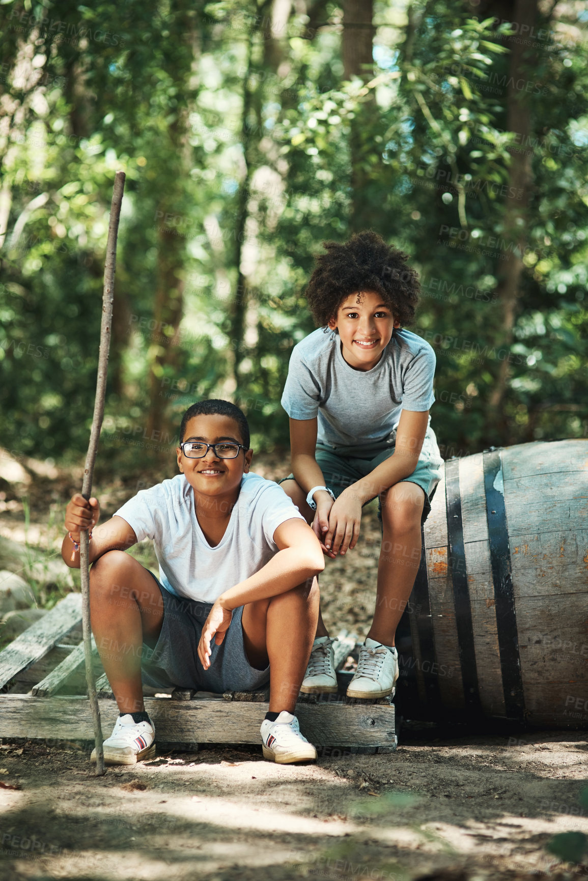 Buy stock photo Shot of two teenage boys exploring nature at summer camp