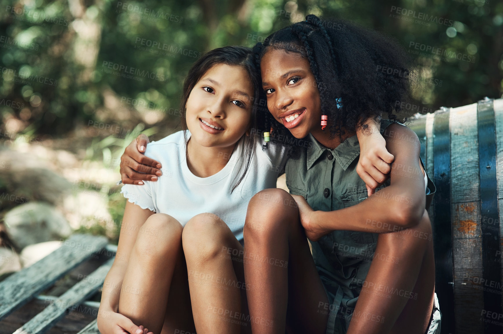 Buy stock photo Shot of two teenage girls embracing in nature at summer camp