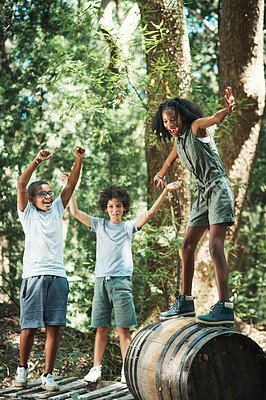 Buy stock photo Shot of a group of teenagers having fun with a barrel in nature at summer camp