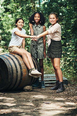 Buy stock photo Shot of a group of teenage girls joining their hands in solidarity at summer camp