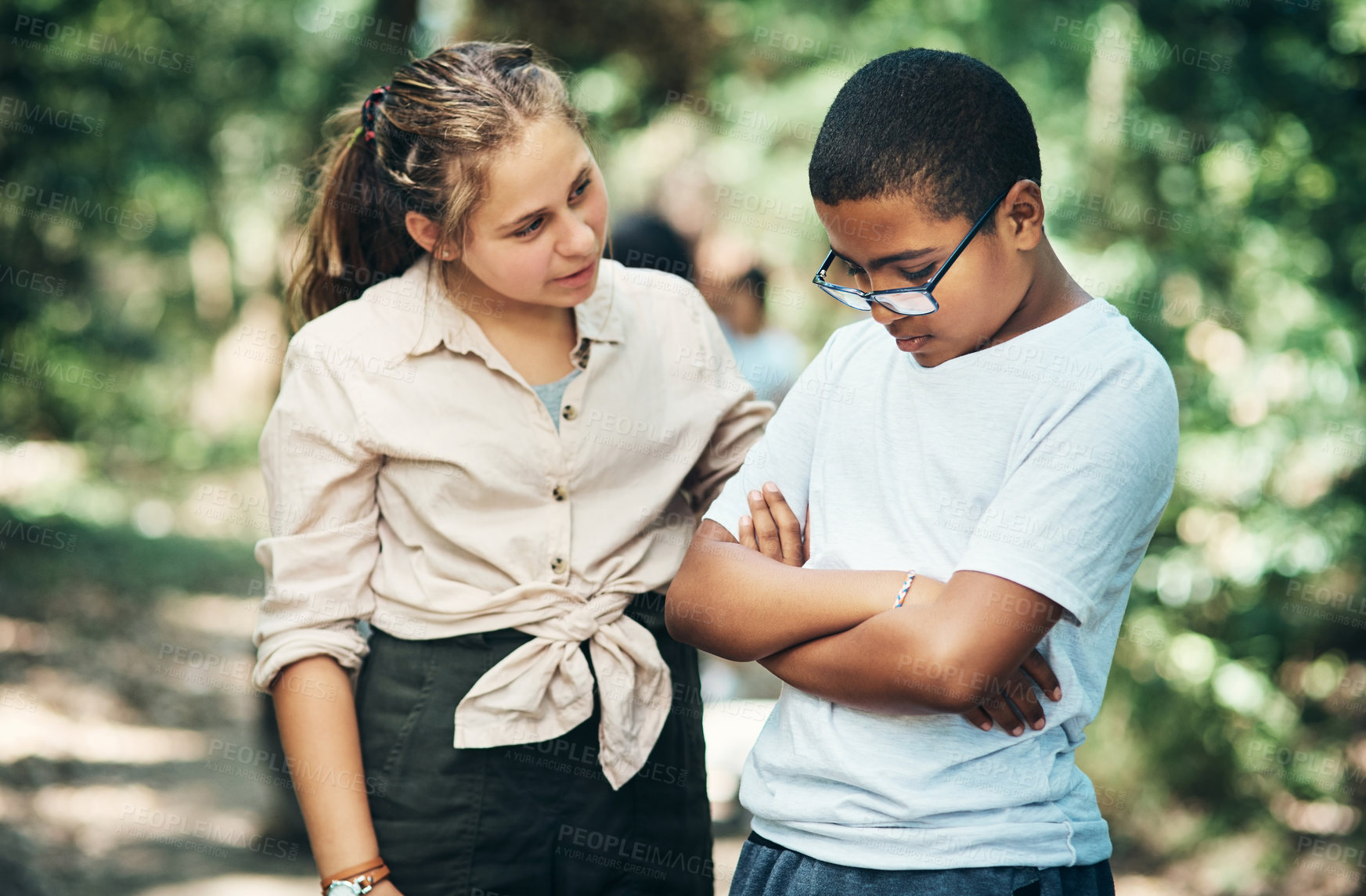 Buy stock photo Shot of a teenage girl comforting her friend during a difficult time at summer camp