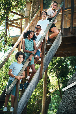 Buy stock photo Shot of a group of teenagers standing next to a treehouse at summer camp