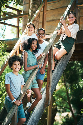 Buy stock photo Shot of a group of teenagers standing next to a treehouse at summer camp