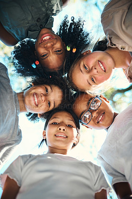 Buy stock photo Shot of a group of teenagers standing in a circle in nature at summer camp