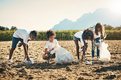 Buy stock photo Shot of a group of teenagers picking up litter off a field at summer camp