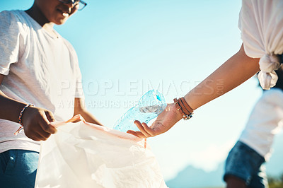 Buy stock photo Shot of two teenagers picking up litter at summer camp