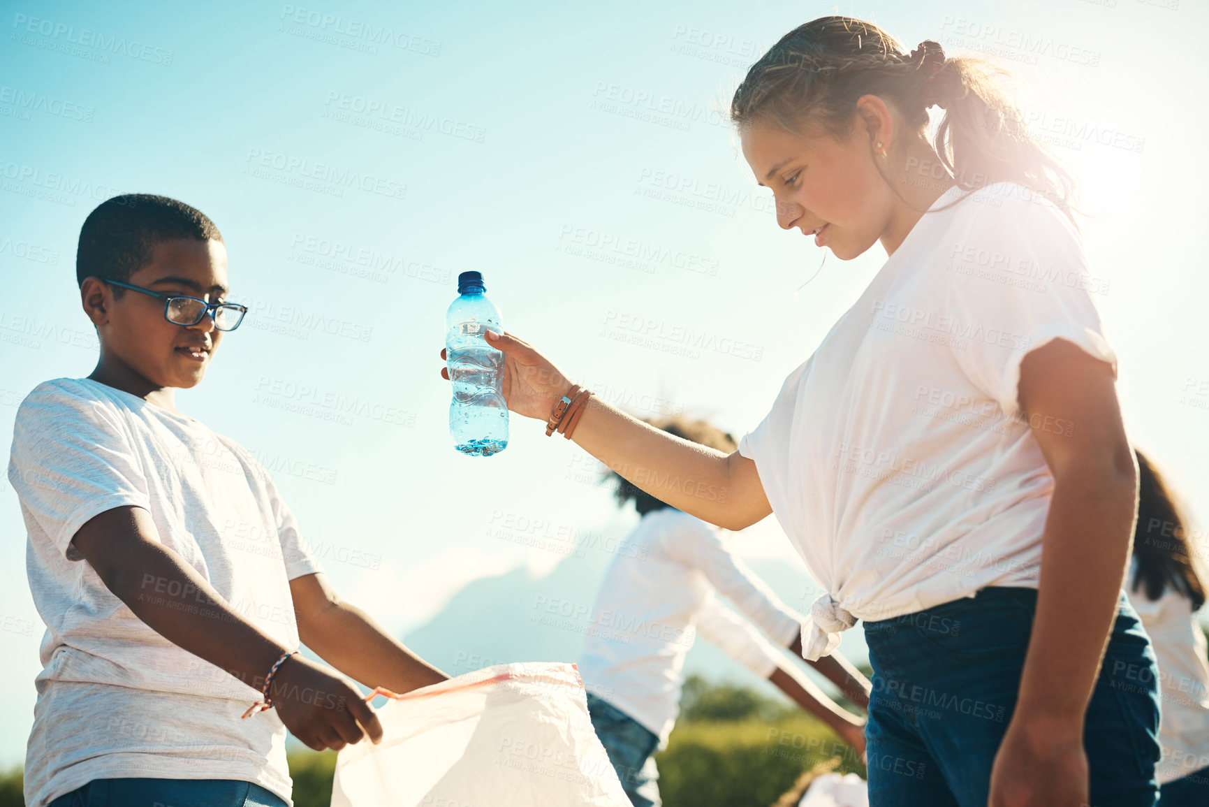 Buy stock photo Shot of a group of teenagers picking up litter summer camp